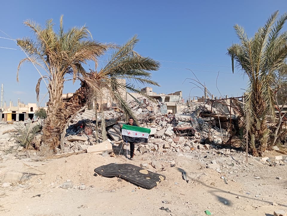 Figure 3: Scenes of destruction and a resident takes his picture in front of his house destroyed by the bombing of Assad's aircraft in the residential city of Palmyra. Photo by Mohamed Fares 2025, Zaher Al-Saleem 2024