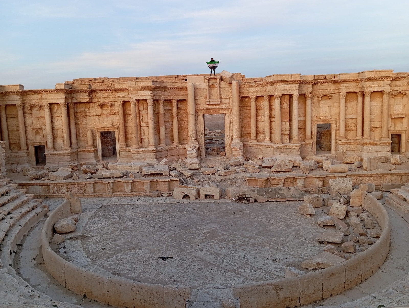 Figure 12: Images from the Palmyra theater before and after the bombing of the façade of the theater. Photo by Hassan Ali 2011, Zaher Al-Saleem 2024